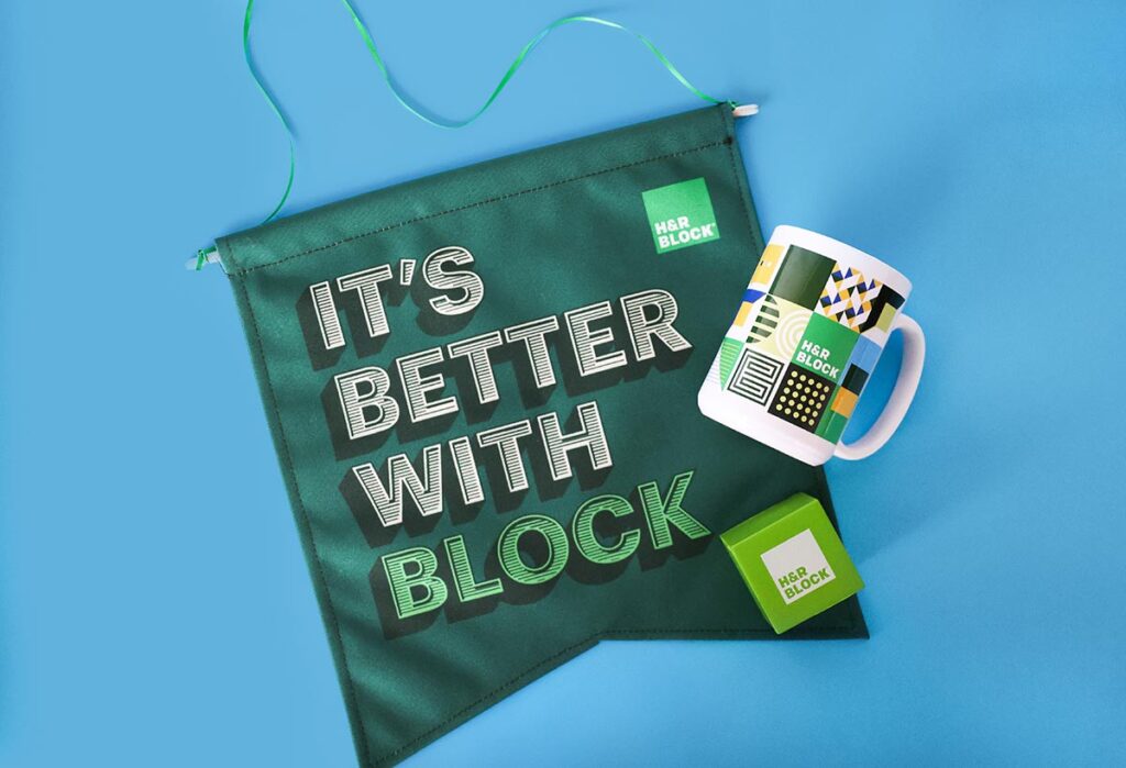 A green banner with the text "IT'S BETTER WITH BLOCK" is displayed alongside a white mug with geometric patterns and an H&R Block logo. A green cube, also featuring the logo, completes the arrangement on a light blue background.